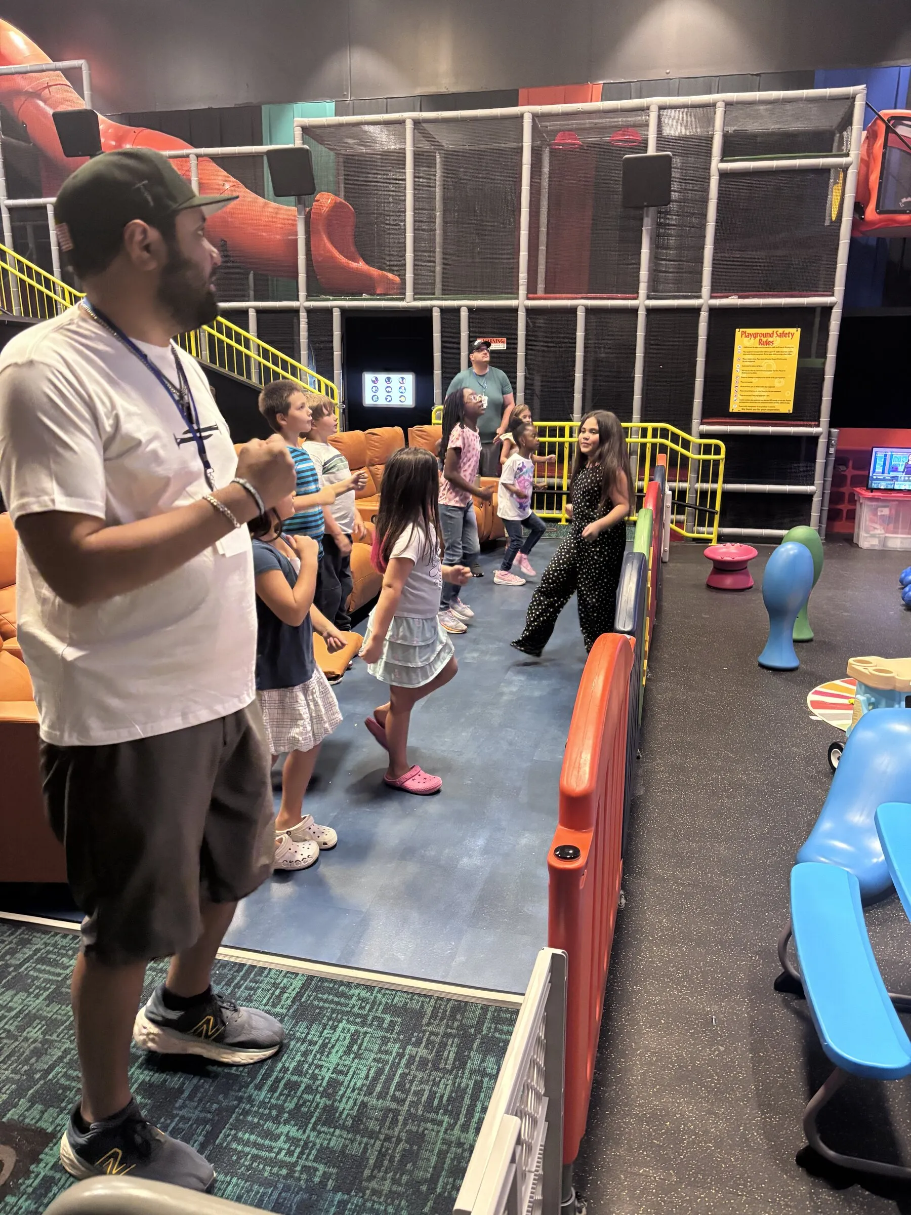 Kids playing in the RevKids play area while a volunteer looks on